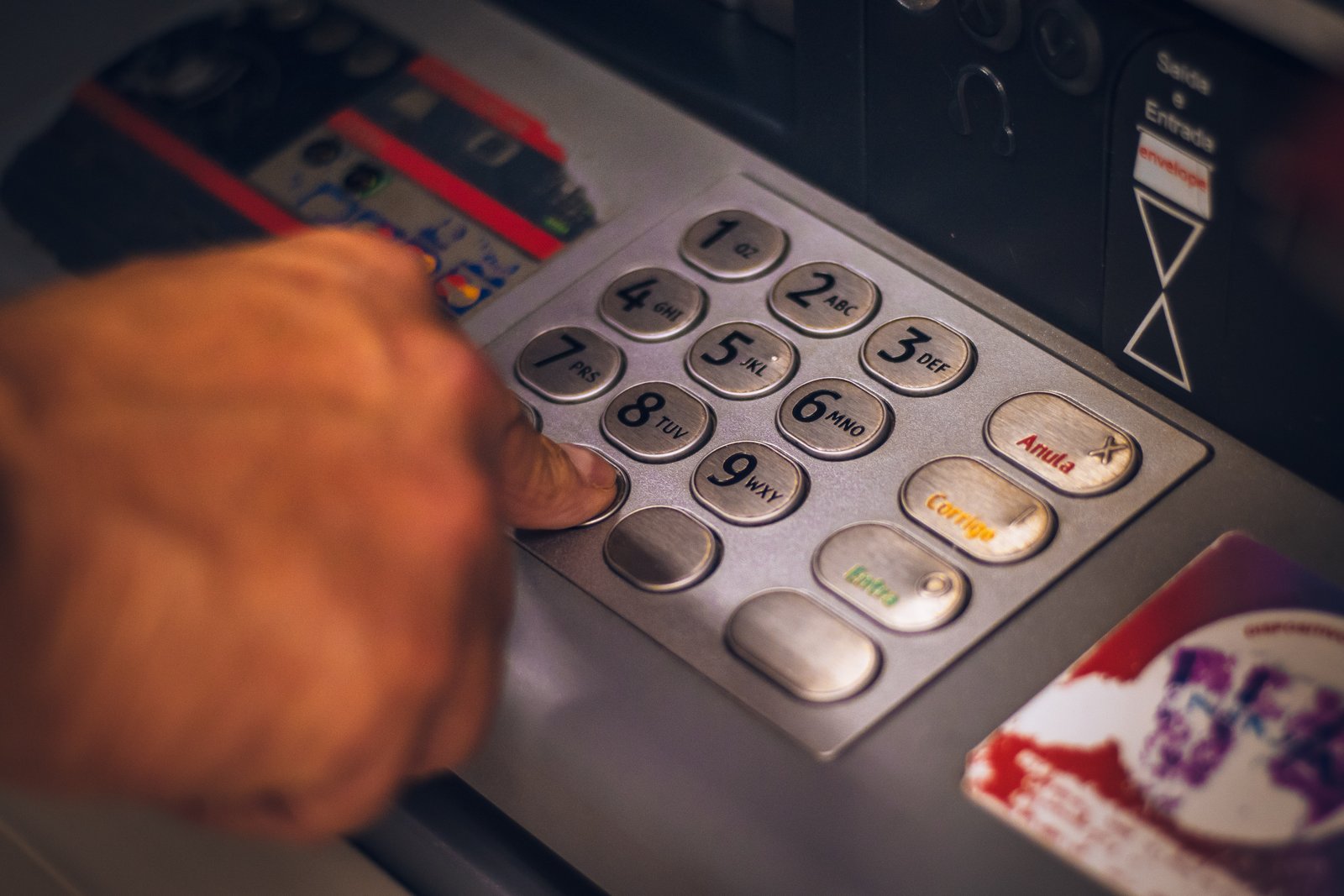 Customer entering numbers in the keypad at the SBI ATM.