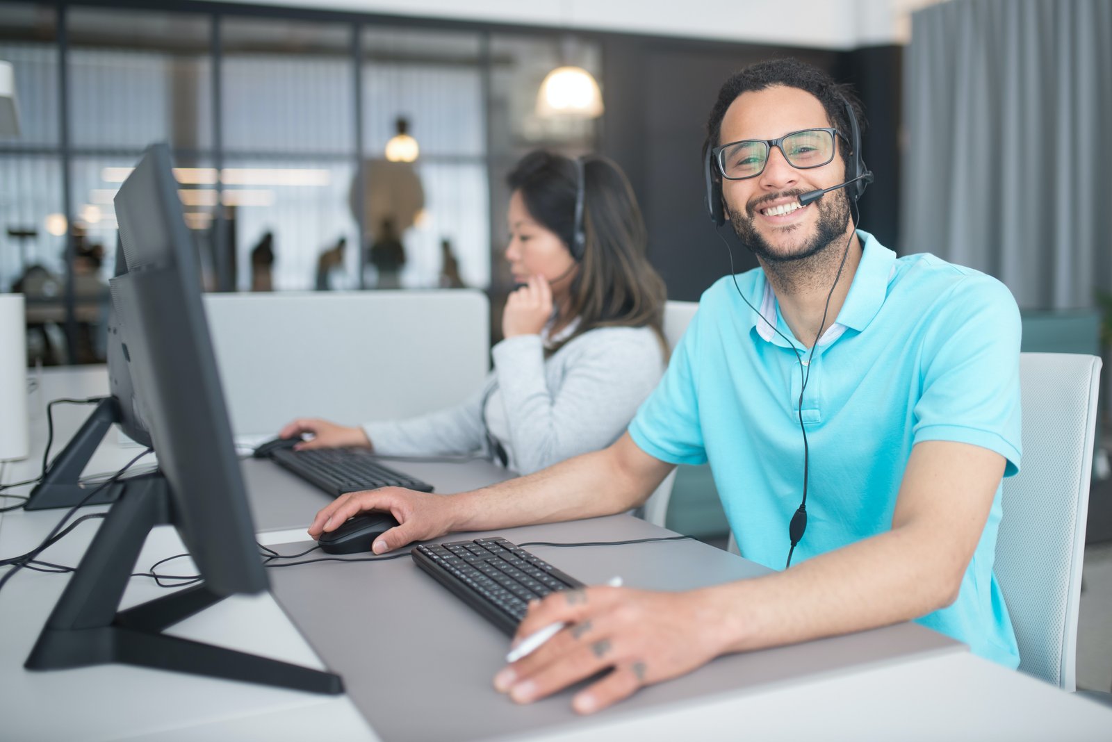 Man and woman working at ICICI India customer care center.