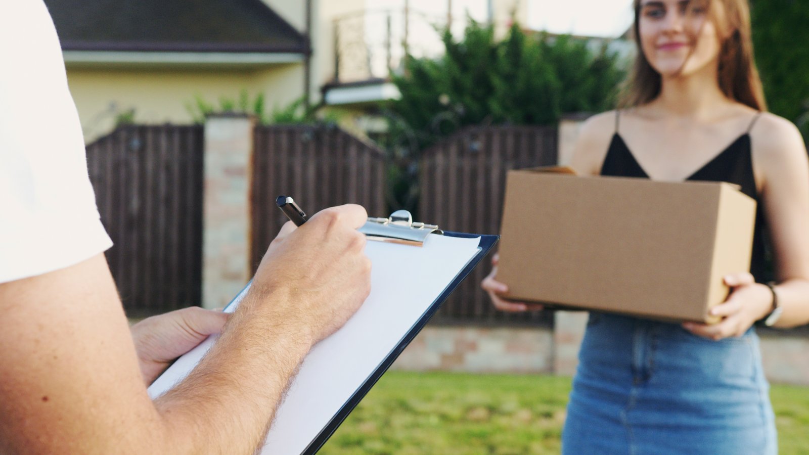 Woman accepting a courier from a delivery person