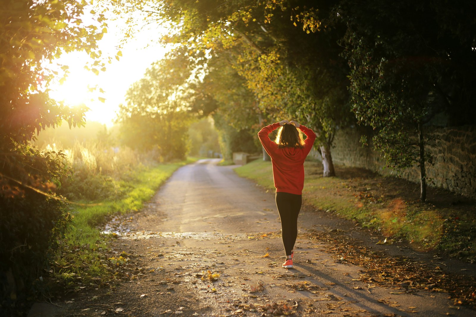 An Indian woman walking among tress at morning