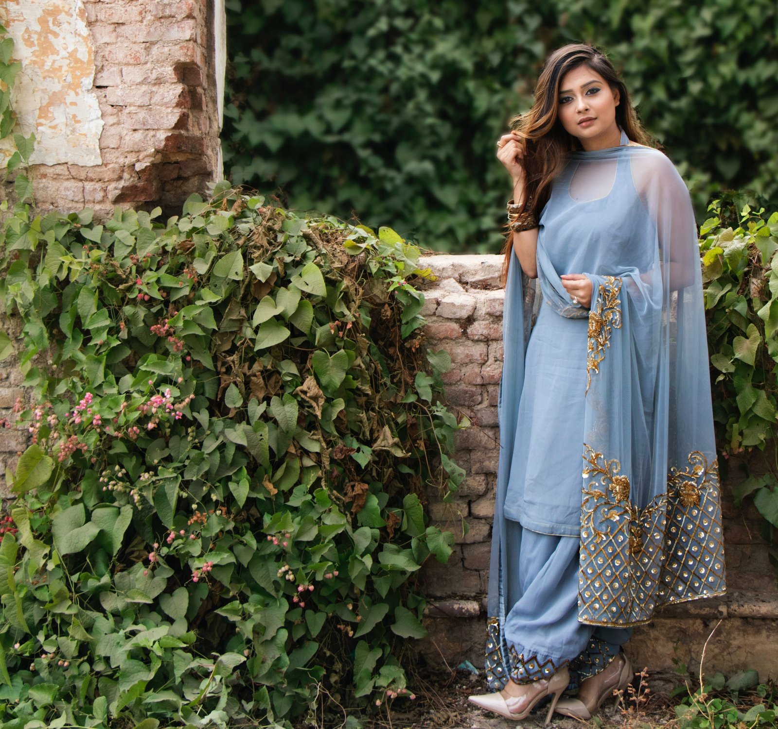 An Indian Girl standing in front of a scenic background