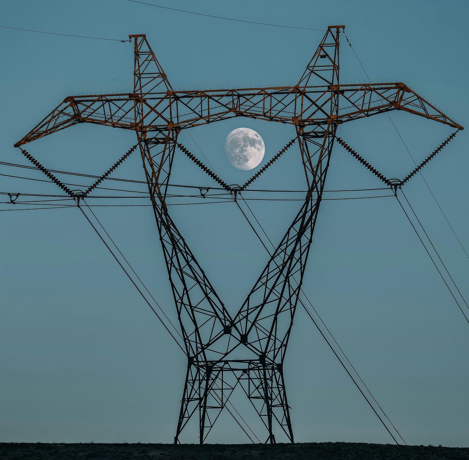 A pylon in Tamil Nadu with electrical lines and having moon in the background